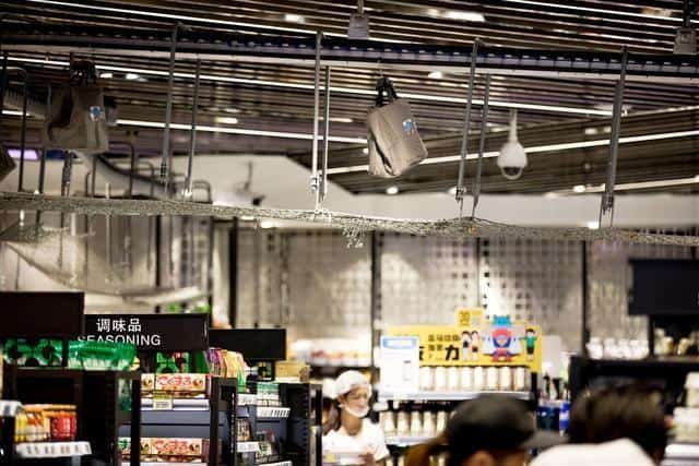 Chinese shoppers pick up online orders at a Hema grocery store.