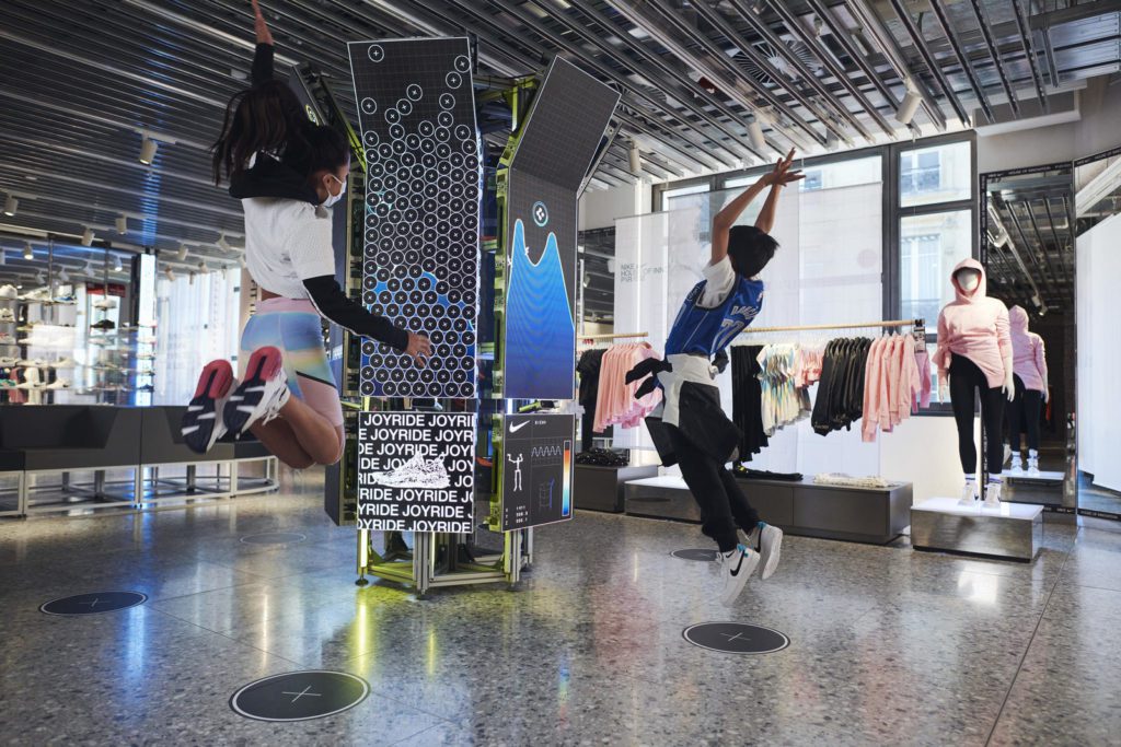 Two kids compete or play together in the Nike Kid Pod