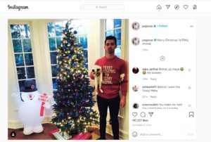 Nick Joans posts on his Instagram wearing an Ugly Christmas Sweater product. 