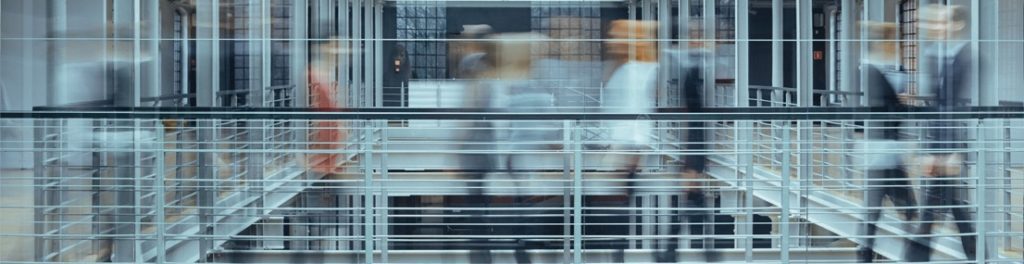 Office workers moving quickly through a corridor