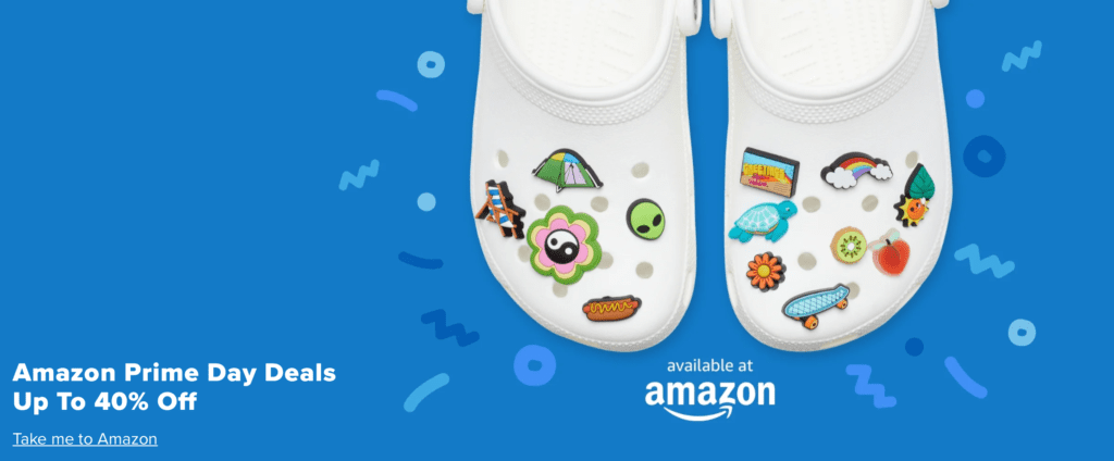A blue banner with white Crocs on it, text reading Amazon Prime Day Deals Up To 40% Off, Available at Amazon"