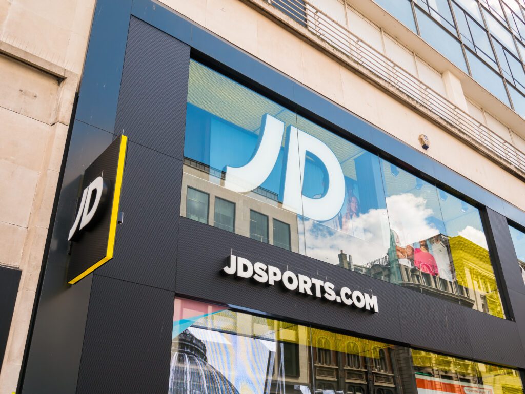 JD Sports connects AI-led shopping interactions to its existing ecommerce infrastructure, including inventory, fulfillment and payments. | Image credit: Alex Yeung - Adobe Stock