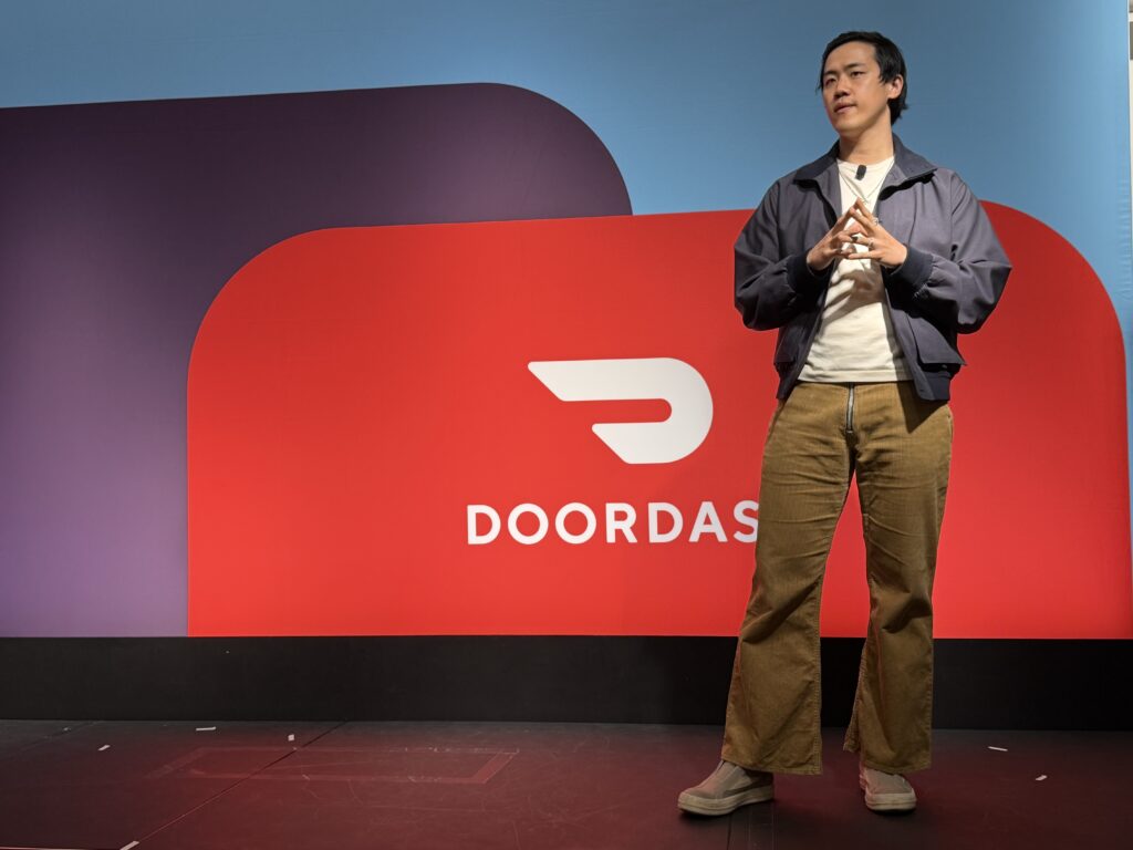 Andy Fang, co-founder and director at DoorDash, speaking at the Dash Forward event in San Francisco about agentic ordering for workplaces | Image credit: Digital Commerce 360